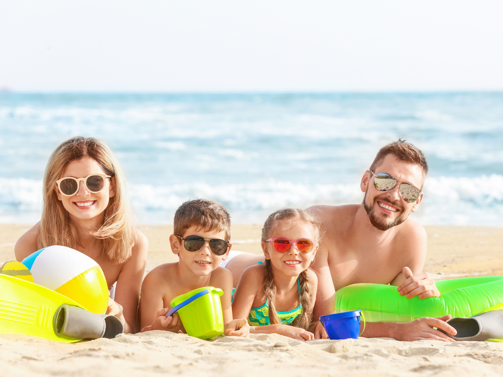 Family relaxing in sand